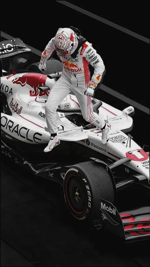 Verstappen climbing out of the white RB21 in the pit lane.